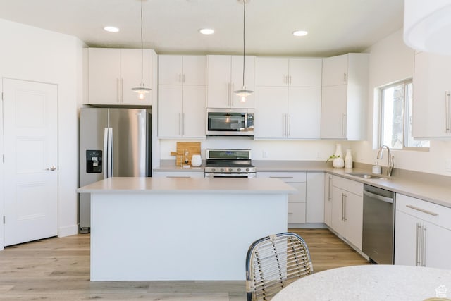 178 W Autumn Ln Unit 136, Saratoga Springs, UT 84045 - kitchen with light countertops, a center island, white cabinetry, appliances with stainless steel finishes, and a sink