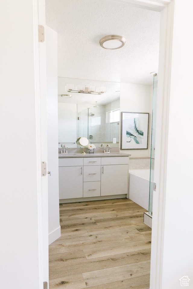 178 W Autumn Ln Unit 136, Saratoga Springs, UT 84045 - full bathroom with a shower, wood finished floors, double vanity, and a sink
