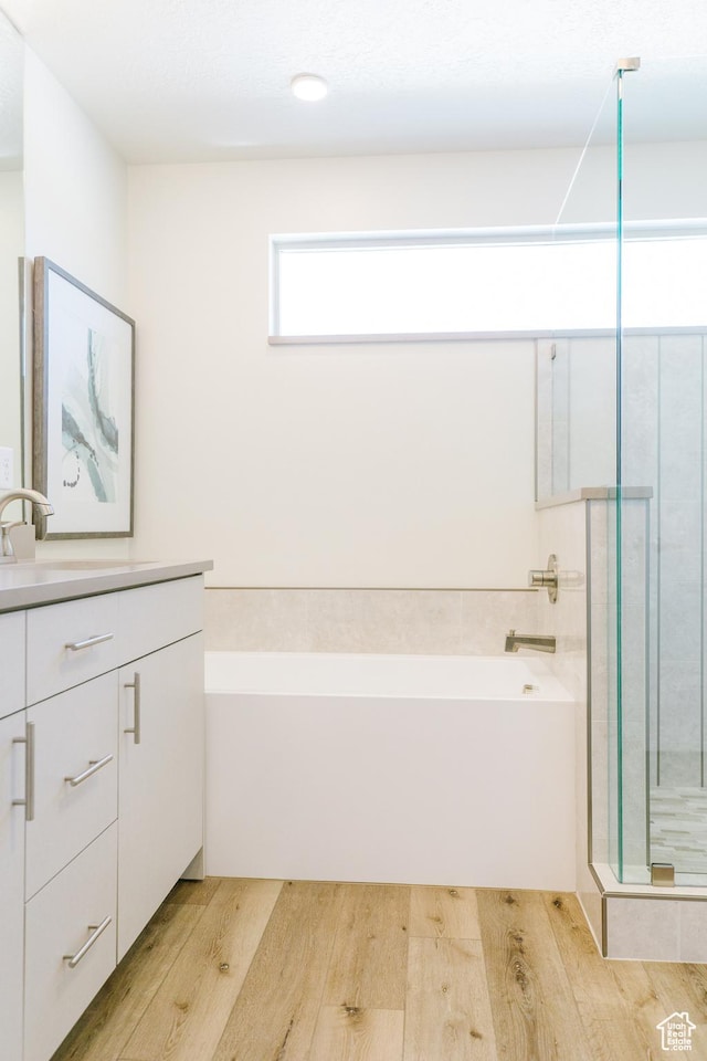 178 W Autumn Ln Unit 136, Saratoga Springs, UT 84045 - bathroom featuring a shower stall, a bath, wood finished floors, and vanity