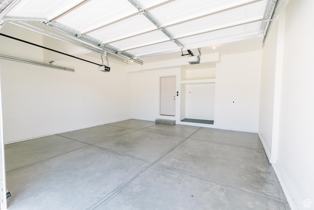 178 W Autumn Ln Unit 136, Saratoga Springs, UT 84045 - garage featuring baseboards and a garage door opener