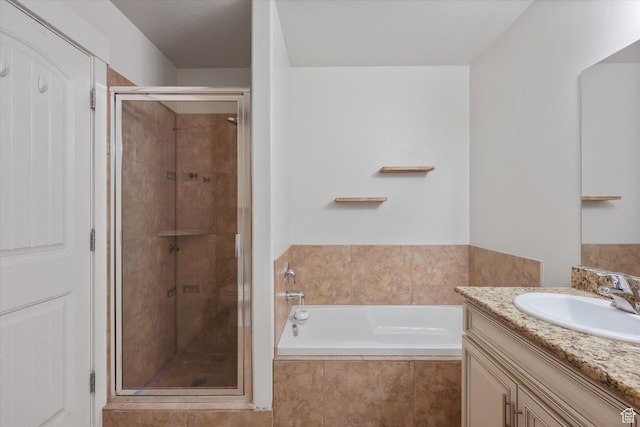 bathroom featuring a garden tub, vanity, and a stall shower