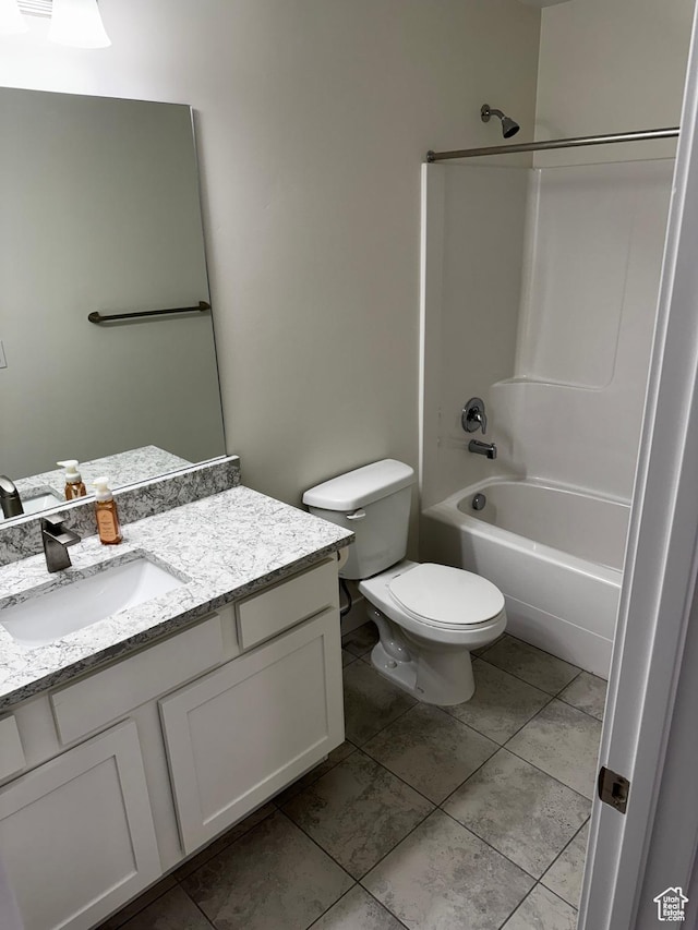 full bathroom with washtub / shower combination, tile patterned flooring, toilet, and vanity