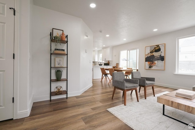 interior space with baseboards, wood finished floors, and recessed lighting