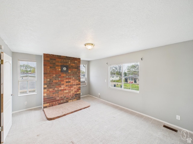 1534 N 300 W, Sunset, UT 84015 - unfurnished living room featuring baseboards, visible vents, a textured ceiling, and carpet flooring