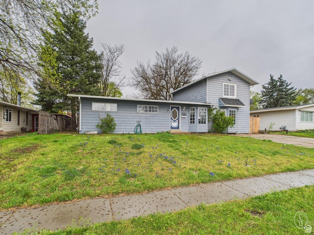 1534 N 300 W, Sunset, UT 84015 - traditional home featuring a front lawn and fence