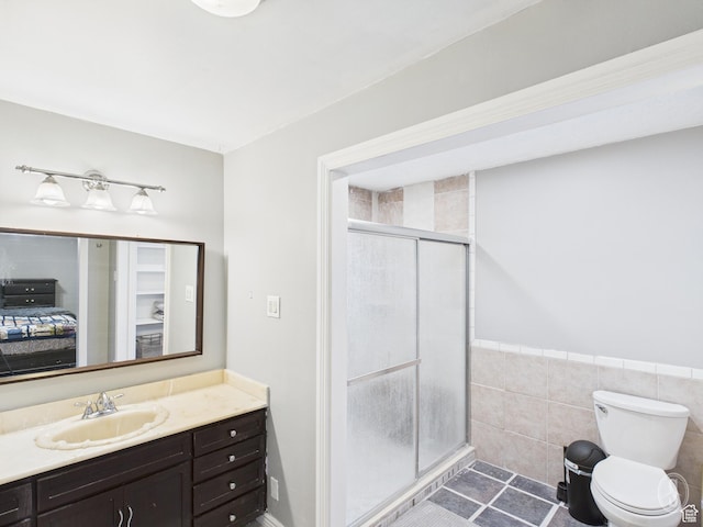 1534 N 300 W, Sunset, UT 84015 - bathroom featuring tile patterned floors, a stall shower, vanity, tile walls, and toilet