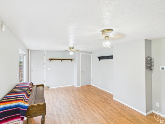 1534 N 300 W, Sunset, UT 84015 - living area with a textured ceiling, light wood finished floors, baseboards, and ceiling fan