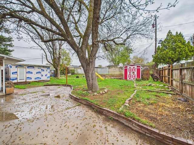 1534 N 300 W, Sunset, UT 84015 - view of yard with a fenced backyard, an outdoor structure, a patio area, and a storage unit