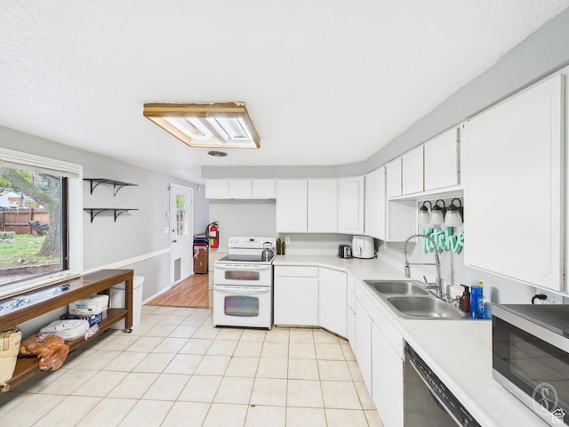 1534 N 300 W, Sunset, UT 84015 - kitchen with a sink, a healthy amount of sunlight, light countertops, stainless steel microwave, and range with two ovens