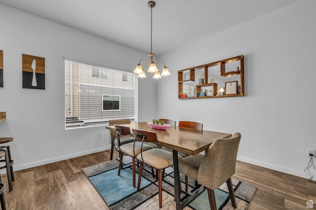 14714 S Rising Star Way, Bluffdale, UT 84065 - dining space featuring wood finished floors, baseboards, and a notable chandelier