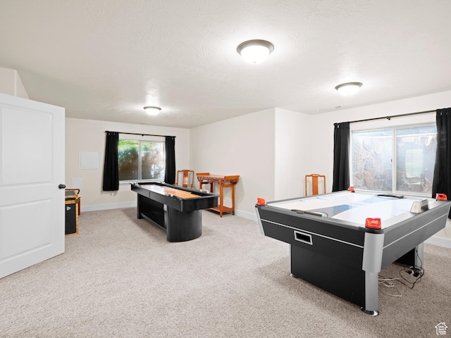recreation room featuring baseboards and light colored carpet
