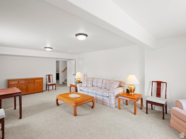 living area featuring light carpet and stairway