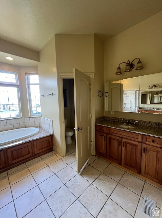 407 W Larkspur Ln, Morgan, UT 84050 - bathroom featuring tile patterned floors, visible vents, toilet, vanity, and a garden tub
