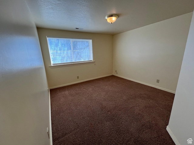 407 W Larkspur Ln, Morgan, UT 84050 - unfurnished room featuring baseboards, dark colored carpet, a textured ceiling, and visible vents