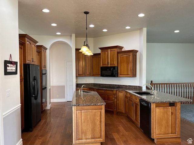 407 W Larkspur Ln, Morgan, UT 84050 - kitchen with dark wood-style floors, dark stone counters, a sink, and black appliances