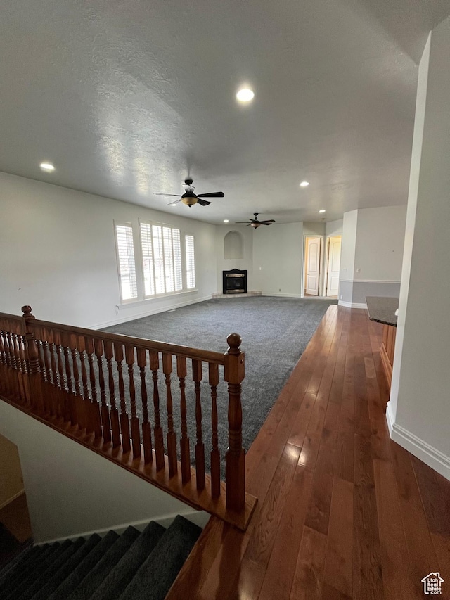 407 W Larkspur Ln, Morgan, UT 84050 - unfurnished living room featuring dark wood finished floors, a glass covered fireplace, baseboards, recessed lighting, and ceiling fan