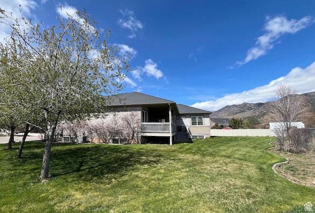 407 W Larkspur Ln, Morgan, UT 84050 - back of property featuring a mountain view, fence, a lawn, stairs, and stucco siding