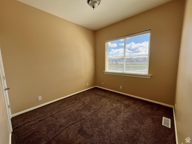 407 W Larkspur Ln, Morgan, UT 84050 - empty room featuring baseboards, visible vents, and dark carpet