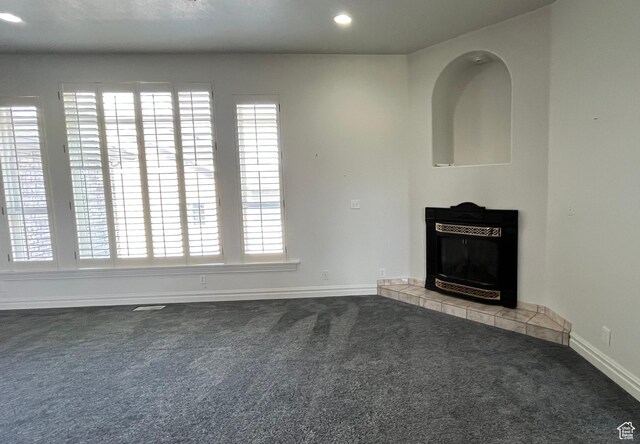 407 W Larkspur Ln, Morgan, UT 84050 - unfurnished living room featuring a tile fireplace, carpet flooring, and baseboards