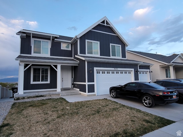 view of front of home with a front lawn, driveway, and a garage