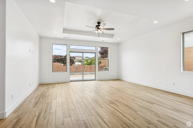 3618 W 185 N, Hurricane, UT 84737 - unfurnished room featuring baseboards, light wood-style flooring, a tray ceiling, and ceiling fan