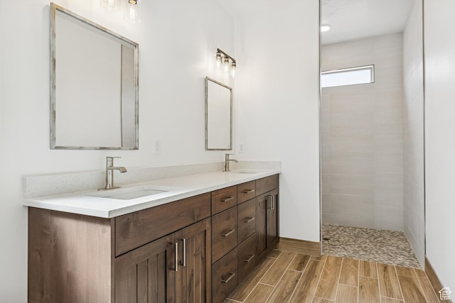 3618 W 185 N, Hurricane, UT 84737 - bathroom featuring wood tiled floor, a sink, double vanity, and tiled shower