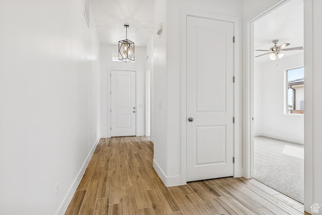 3618 W 185 N, Hurricane, UT 84737 - hallway with light wood-type flooring, baseboards, and an inviting chandelier