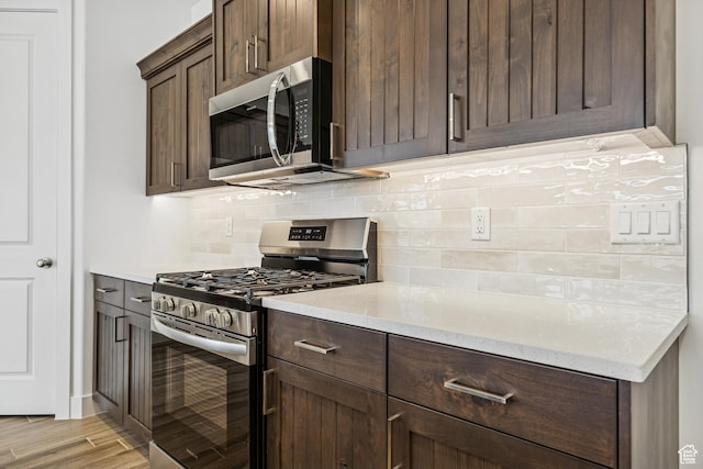 3618 W 185 N, Hurricane, UT 84737 - kitchen with decorative backsplash, appliances with stainless steel finishes, dark brown cabinets, and light wood-style flooring