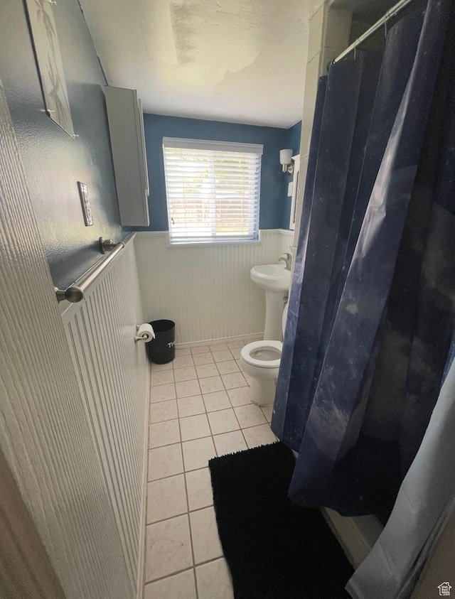 4584 S Knightsbridge Rd, Taylorsville, UT 84129 - bathroom featuring tile patterned flooring, toilet, a shower with curtain, and a wainscoted wall