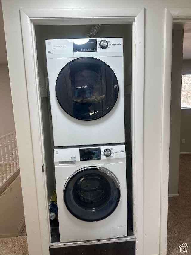 4584 S Knightsbridge Rd, Taylorsville, UT 84129 - clothes washing area with baseboards, carpet flooring, stacked washer / dryer, and laundry area