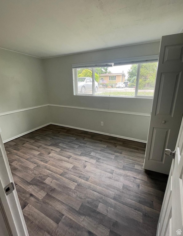 4584 S Knightsbridge Rd, Taylorsville, UT 84129 - unfurnished bedroom featuring dark wood-type flooring and baseboards