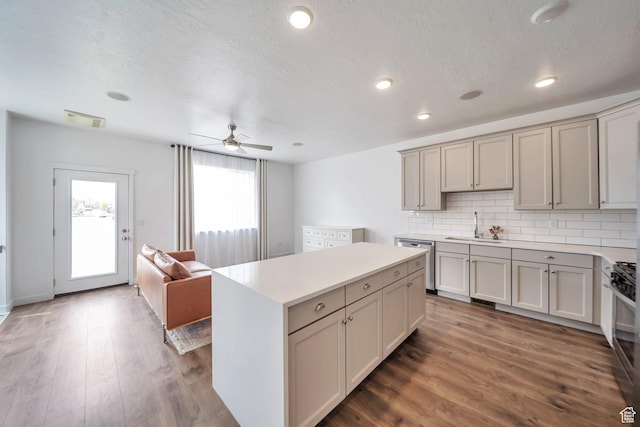 kitchen featuring gray cabinets, backsplash, appliances with stainless steel finishes, and a sink
