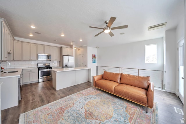 living area with recessed lighting, wood finished floors, visible vents, and a ceiling fan