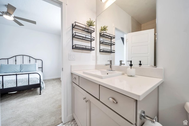 bathroom with baseboards, vanity, and ceiling fan