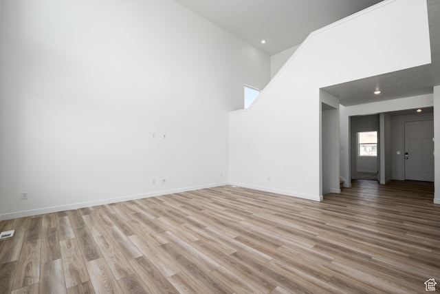 1784 E Bison Dr Unit B234, Eagle Mountain, UT 84005 - unfurnished living room featuring recessed lighting, light wood-style flooring, and baseboards