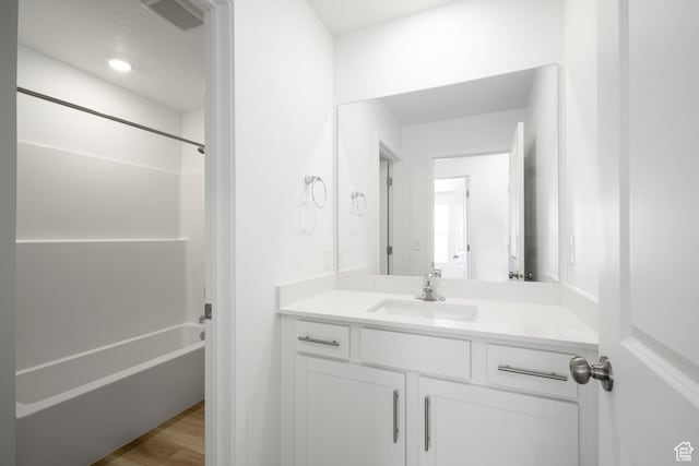 1784 E Bison Dr Unit B234, Eagle Mountain, UT 84005 - bathroom featuring  shower combination, vanity, wood finished floors, and visible vents