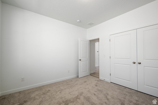 1784 E Bison Dr Unit B234, Eagle Mountain, UT 84005 - unfurnished bedroom with baseboards, visible vents, a closet, and light colored carpet