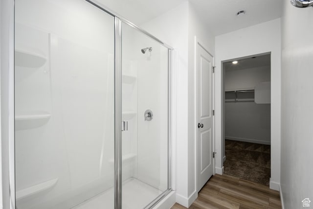 1784 E Bison Dr Unit B234, Eagle Mountain, UT 84005 - full bath with wood finished floors, a spacious closet, and a stall shower