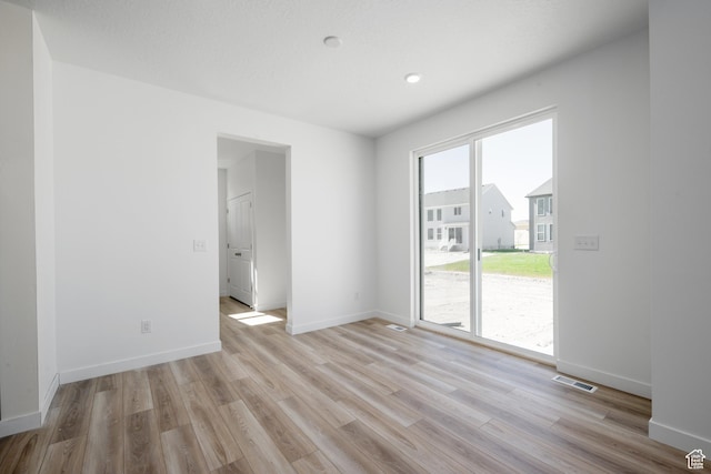 1784 E Bison Dr Unit B234, Eagle Mountain, UT 84005 - unfurnished room featuring baseboards, light wood-style flooring, and visible vents