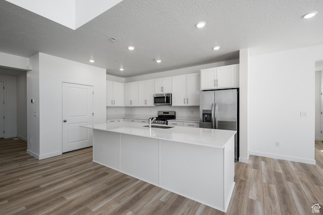 1784 E Bison Dr Unit B234, Eagle Mountain, UT 84005 - kitchen featuring baseboards, appliances with stainless steel finishes, a sink, and a textured ceiling