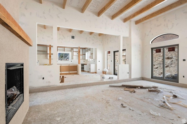 126 W Bowler Rd, Gunlock, UT 84733 - unfurnished living room featuring a towering ceiling and beam ceiling