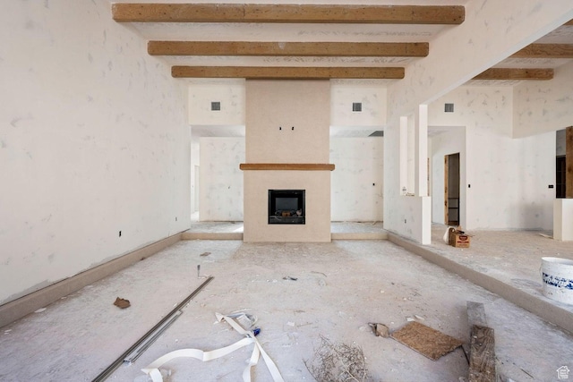 126 W Bowler Rd, Gunlock, UT 84733 - unfurnished living room with a fireplace, visible vents, and beam ceiling