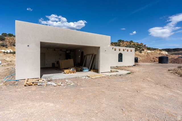 126 W Bowler Rd, Gunlock, UT 84733 - view of home's exterior with stucco siding and a garage