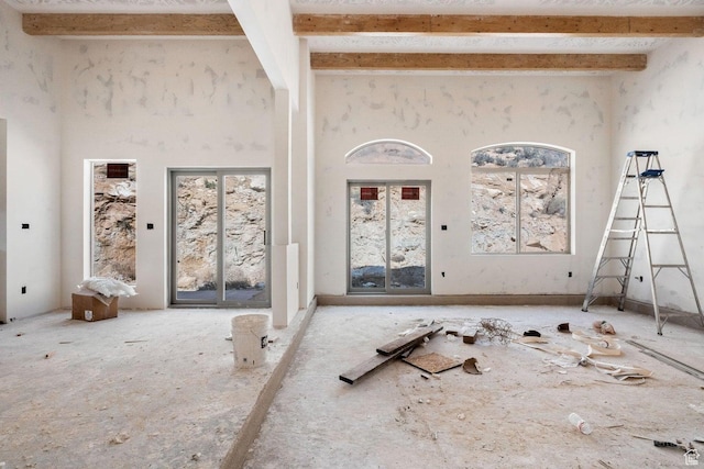126 W Bowler Rd, Gunlock, UT 84733 - unfurnished living room featuring beamed ceiling and a high ceiling