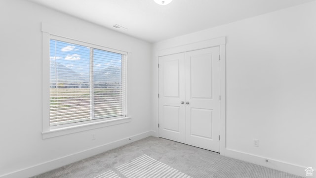 794 Brook Ave E, Tooele, UT 84074 - unfurnished bedroom featuring light carpet, a closet, visible vents, and baseboards