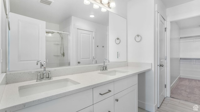 794 Brook Ave E, Tooele, UT 84074 - bathroom featuring visible vents, a sink, double vanity, and a stall shower