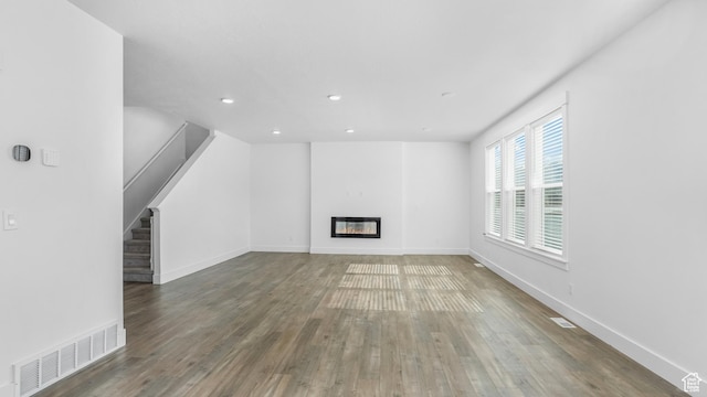 794 Brook Ave E, Tooele, UT 84074 - unfurnished living room with wood finished floors, visible vents, recessed lighting, and stairway