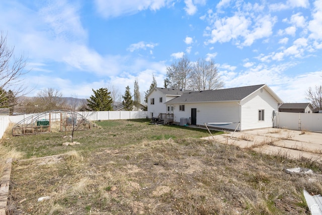 view of yard with a fenced backyard, a garden, and central AC