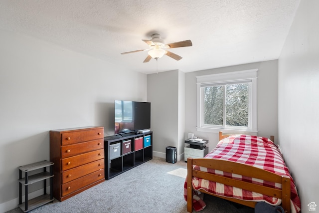 bedroom featuring a textured ceiling, carpet flooring, baseboards, and ceiling fan