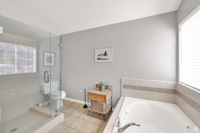bathroom with a garden tub, a stall shower, toilet, lofted ceiling, and tile patterned flooring